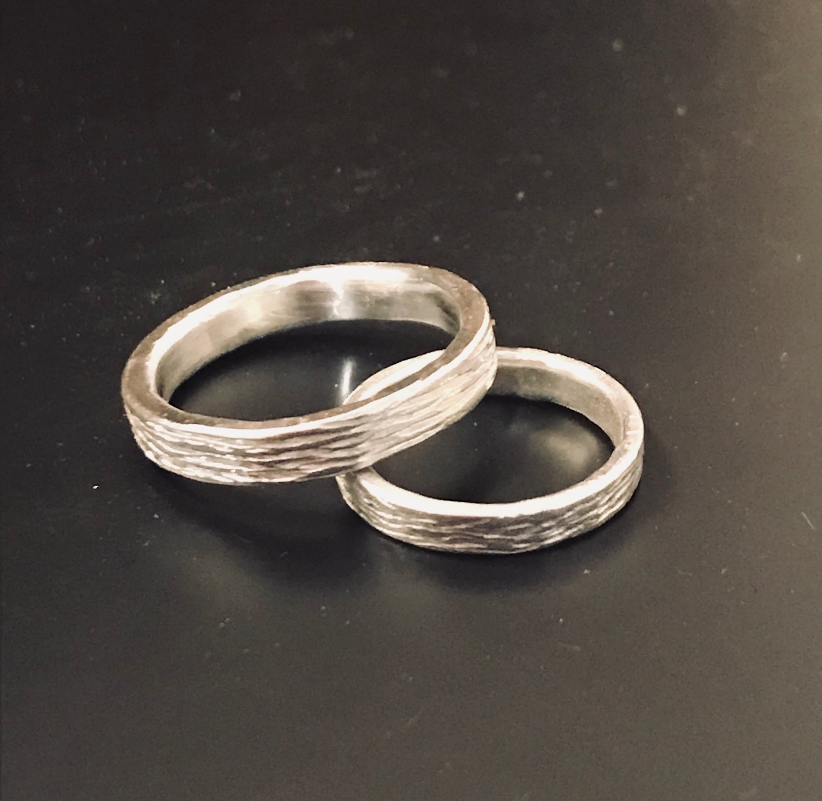 Pareja de alianzas de textura irregular en plata trabajada a mano